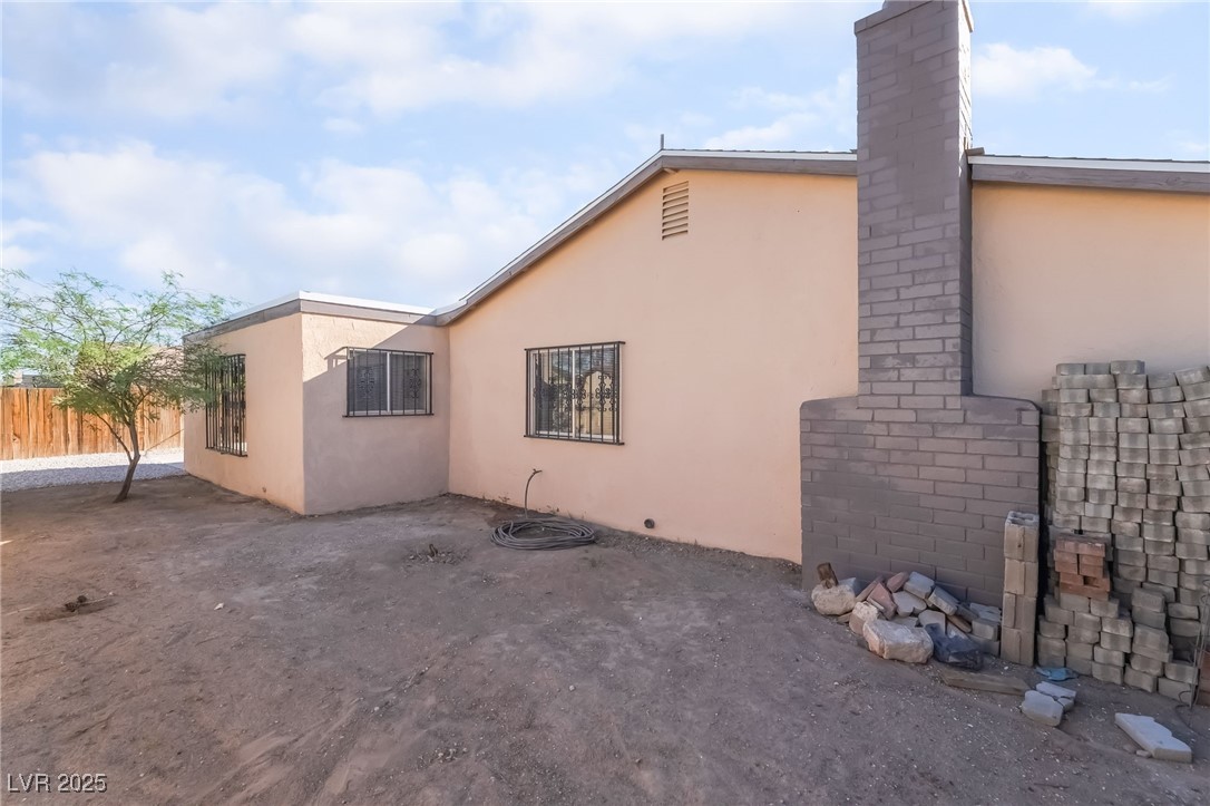 2246 East Russell Road Las Vegas, NV 89119 - Photo 21 of 24 View of side of home with stucco siding and a chimney