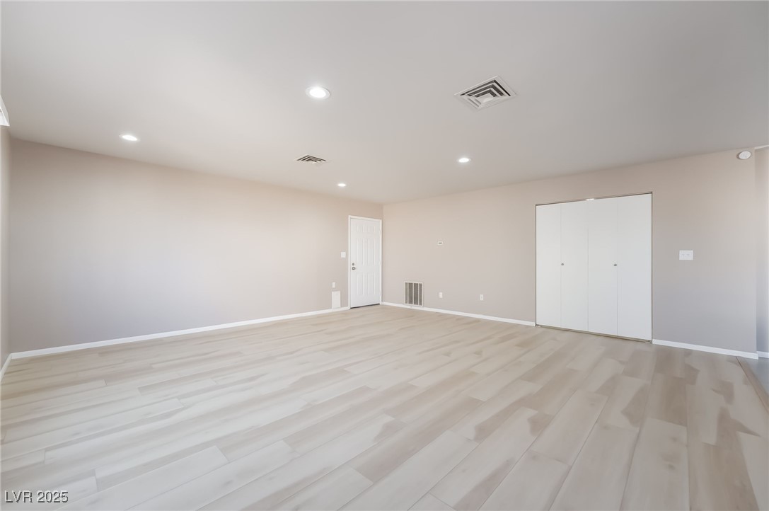 2246 East Russell Road Las Vegas, NV 89119 - Photo 4 of 24 Unfurnished room featuring light wood-style floors and recessed lighting