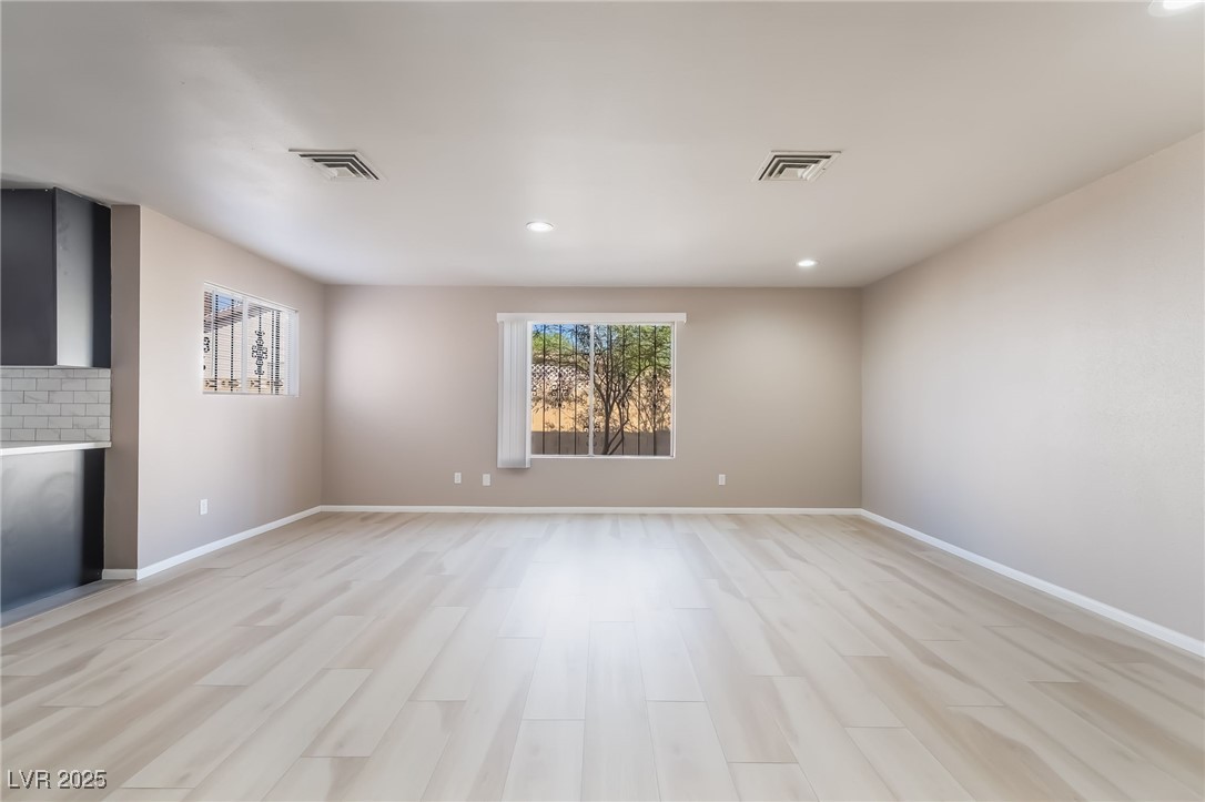 2246 East Russell Road Las Vegas, NV 89119 - Photo 9 of 24 Unfurnished living room with light wood finished floors and recessed lighting