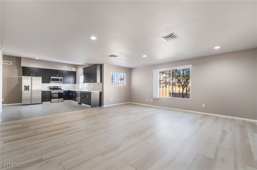 2246 East Russell Road Las Vegas, NV 89119 - Photo 10 of 24 Unfurnished living room with light wood-style floors and recessed lighting