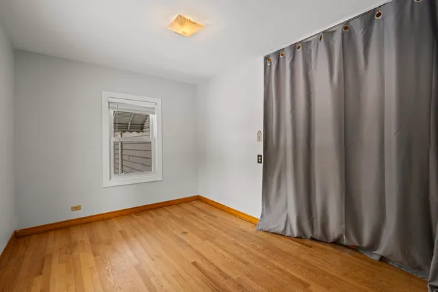 an empty room with wooden floor and closet