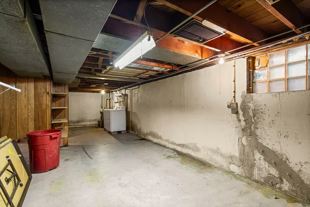 a front view of a house with a snow and trees