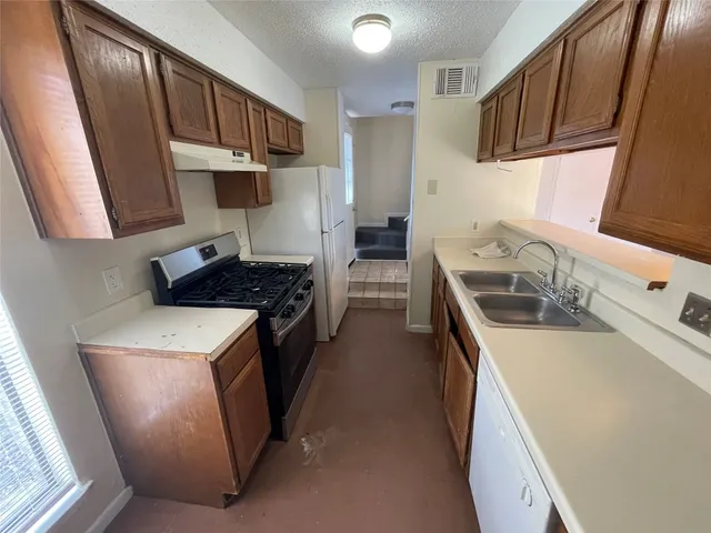 a view of backyard with seating space and wooden fence