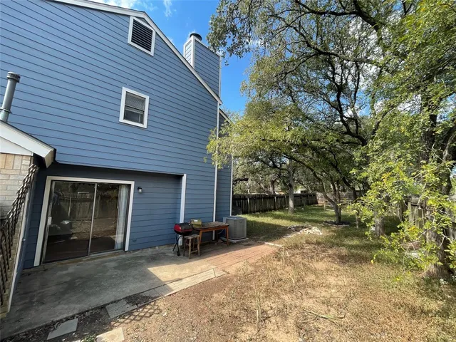 a view of a backyard with large trees