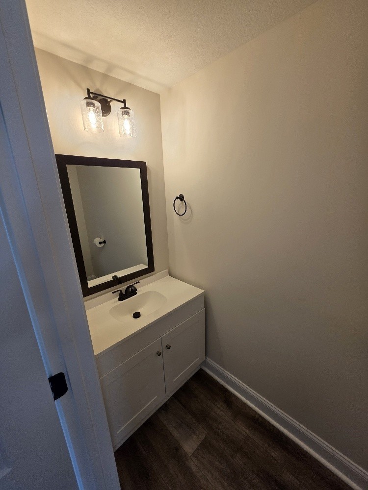 550 Peachers Mill Road, Unit A2 Clarksville, TN 37042 - Photo 6 of 15 a room with a mirror and a wooden floor