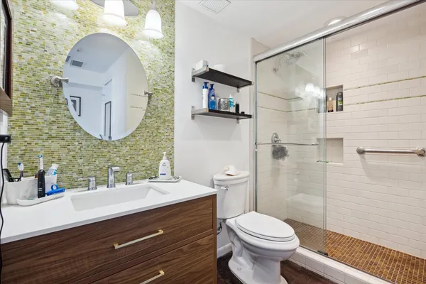 a bathroom with a toilet a sink and mirror