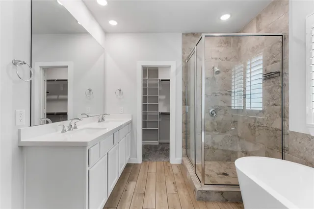 a spacious bathroom with a shower sink vanity mirror and toilet