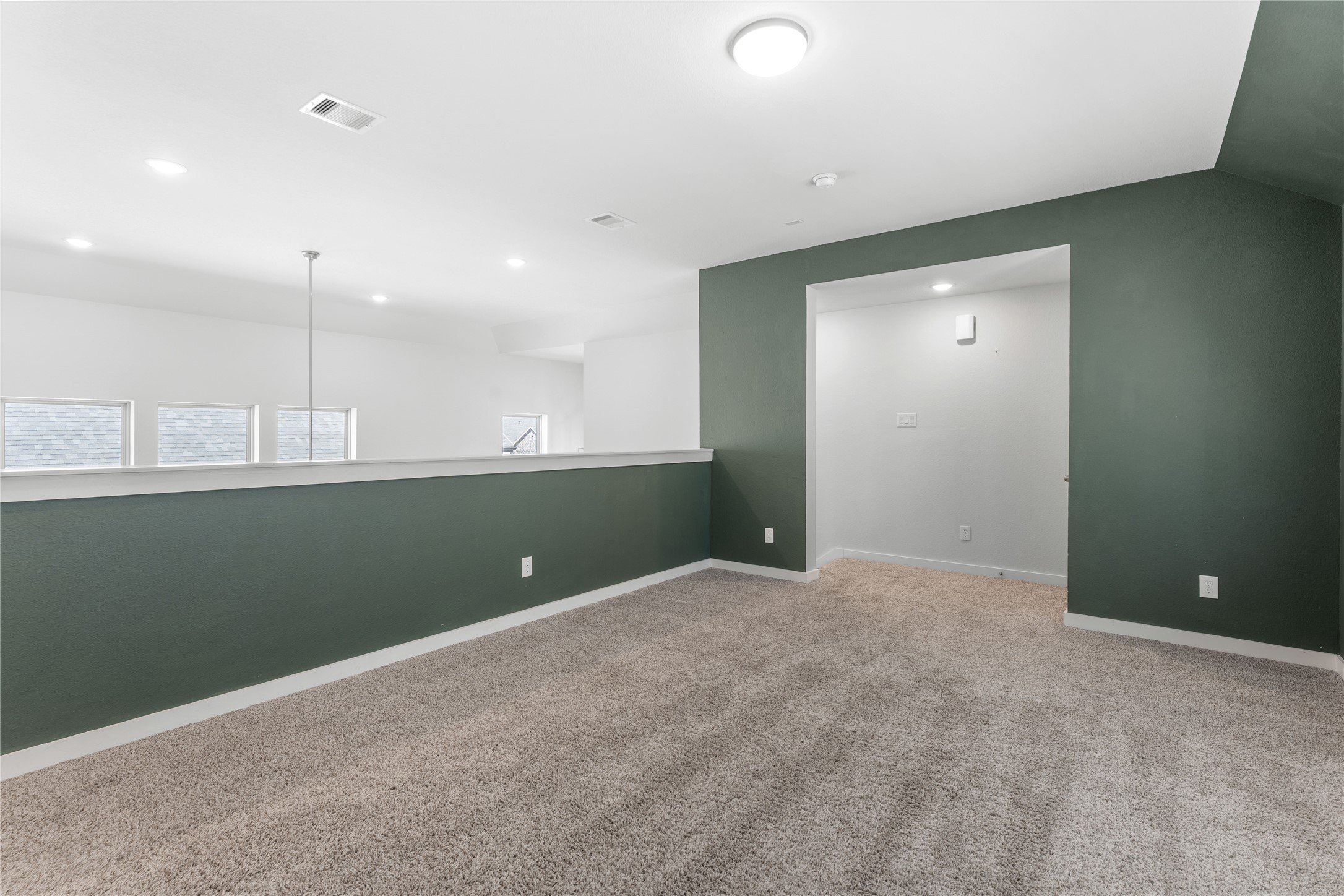 439 Flowering Lotus Court Conroe, TX 77318 - Photo 22 of 33 a view of an empty room with kitchen and a window