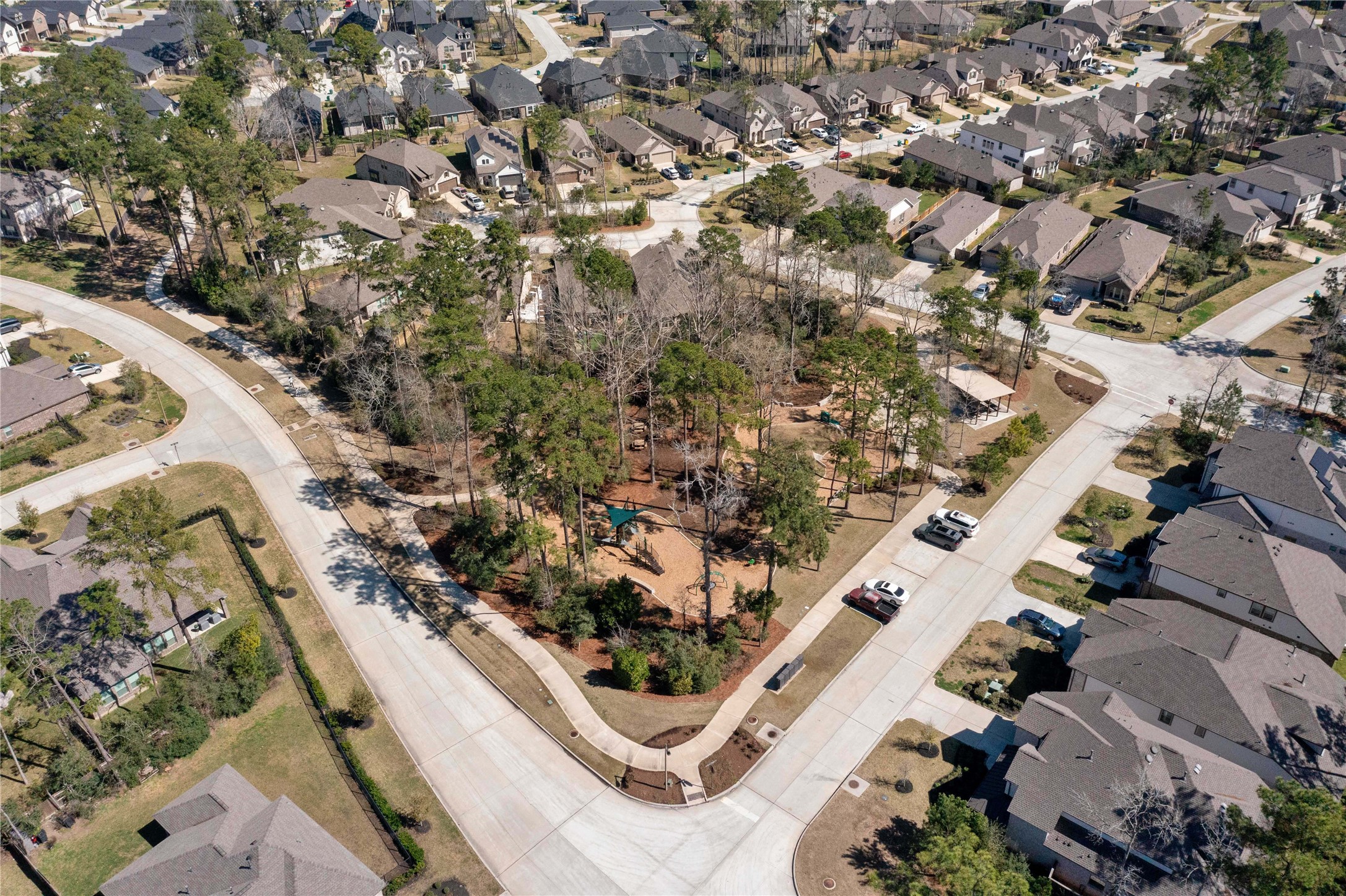 439 Flowering Lotus Court Conroe, TX 77318 - Photo 30 of 33 an aerial view of a house with a yard and mountain view in back