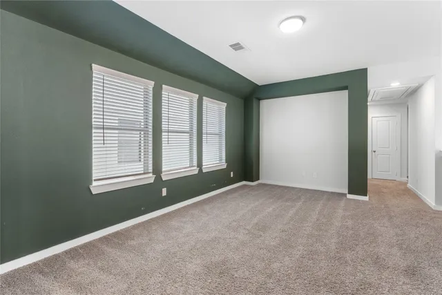 an empty room with windows and closet