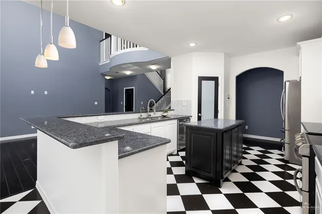 a kitchen with a sink a counter and cabinets