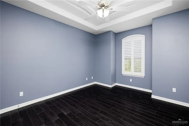 a view of wooden floor and windows in a room