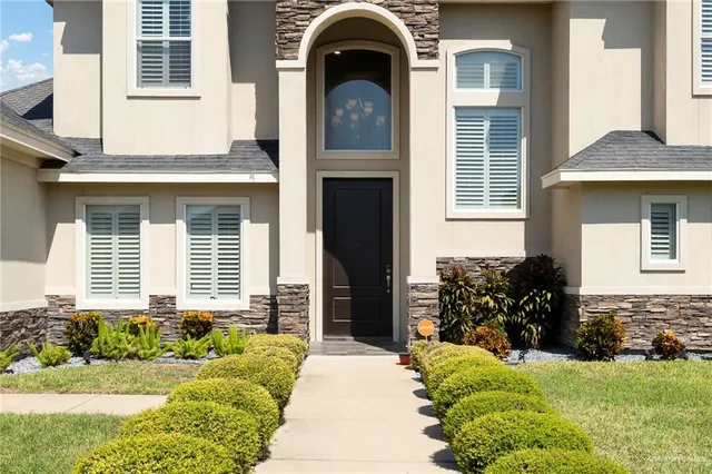 a front view of a house with garden