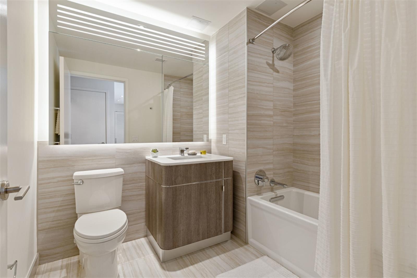 19 Dutch Street, Unit 18B Manhattan, NY 10038 - Photo 5 of 22 a bathroom with a sink toilet and shower