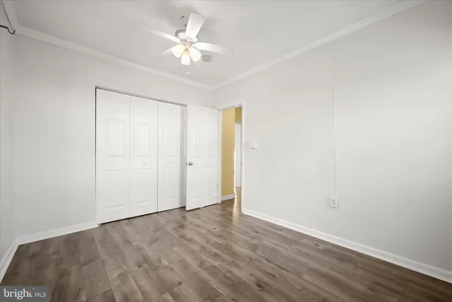 a view of an empty room with a fan