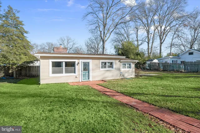 a view of a house with a yard and plants