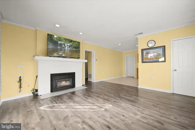 a view of an empty room with a fireplace