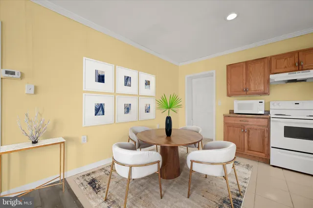 a living room with furniture a rug and a dining table
