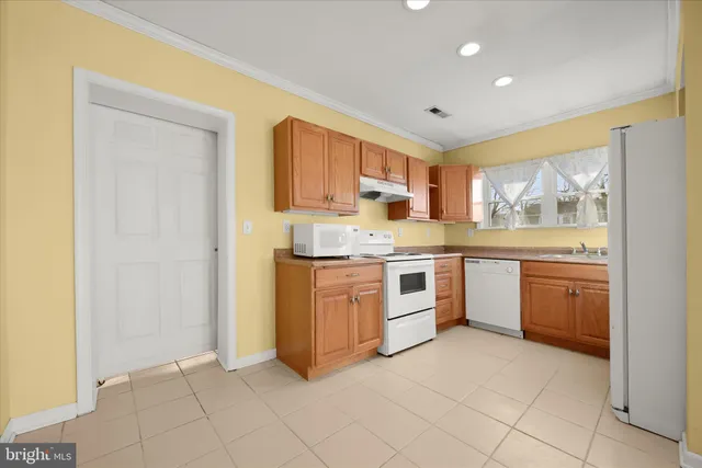 a kitchen with a stove a sink and a refrigerator