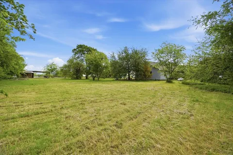 a view of a field with an ocean