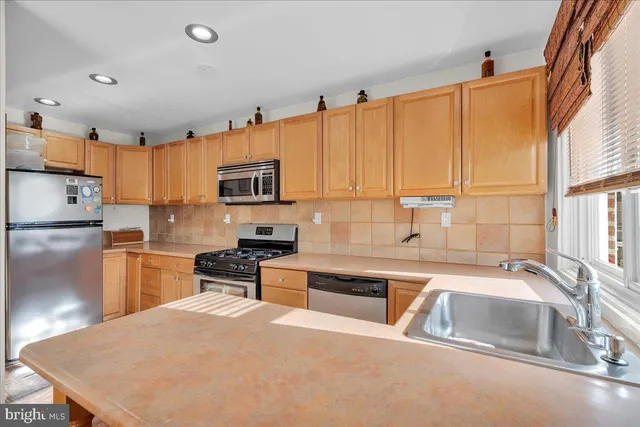 a kitchen that has a sink and a stove top oven