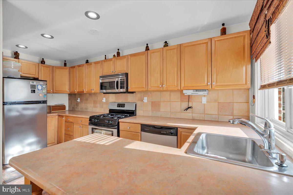 8504 Forrest Avenue Philadelphia, PA 19150 - Photo 8 of 23 a kitchen that has a sink and a stove top oven