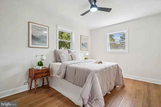 a bedroom with a bed and a painting on the wall