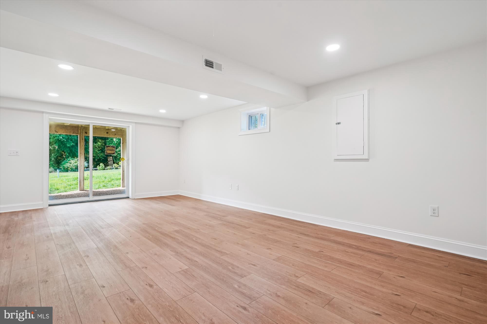 1030 Stephen Reid Drive Huntingtown, MD 20639 - Photo 19 of 30 a view of an empty room with wooden floor and a window