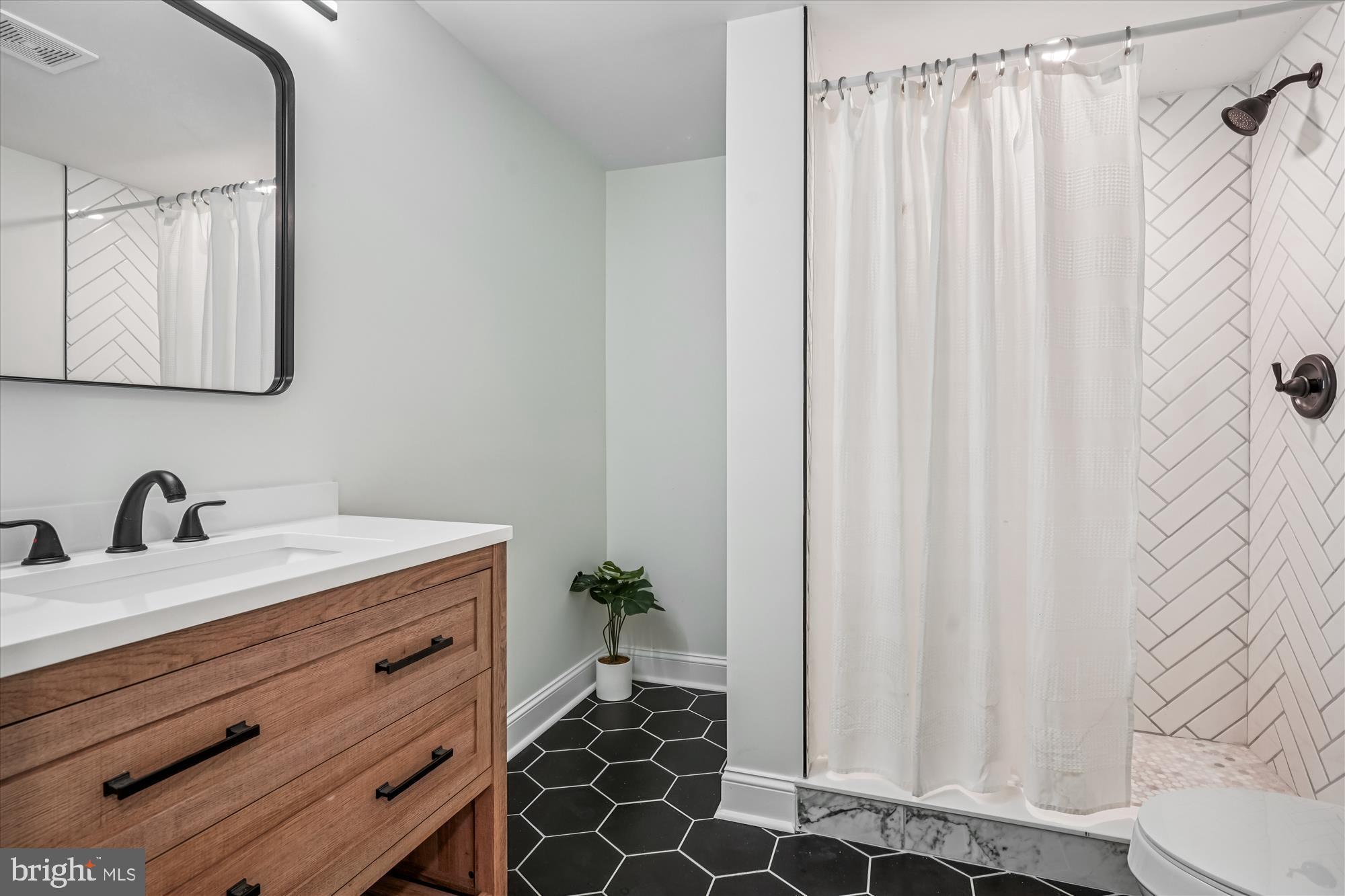 1030 Stephen Reid Drive Huntingtown, MD 20639 - Photo 23 of 30 a bathroom with a granite countertop sink and a mirror