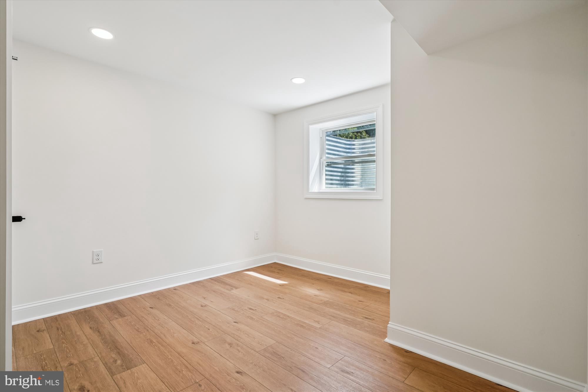 1030 Stephen Reid Drive Huntingtown, MD 20639 - Photo 25 of 30 an empty room with wooden floor and windows