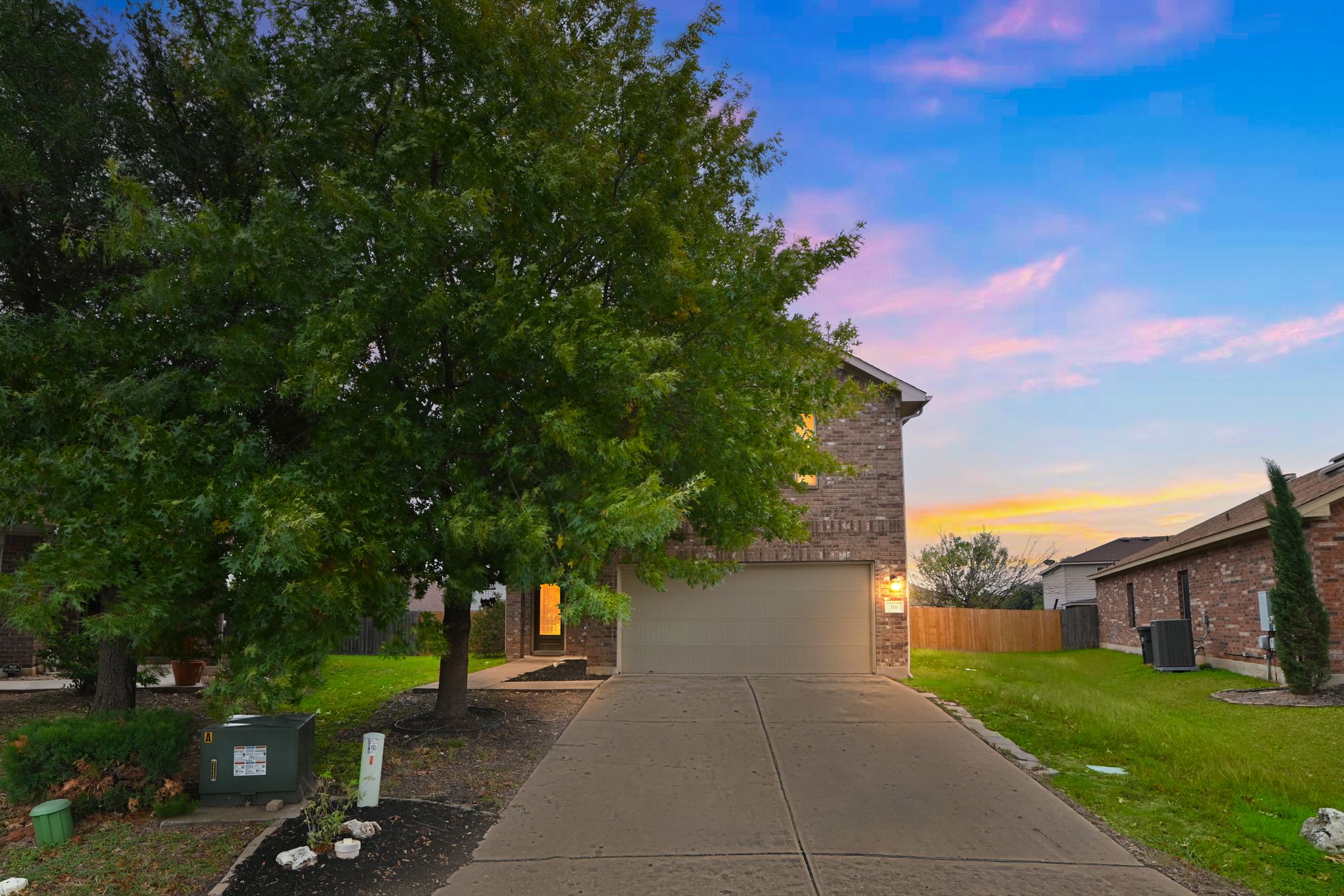 316 Housefinch Loop Leander, TX 78641 - Photo 1 of 37 Welcoming exterior with mature shade tree and extended driveway.