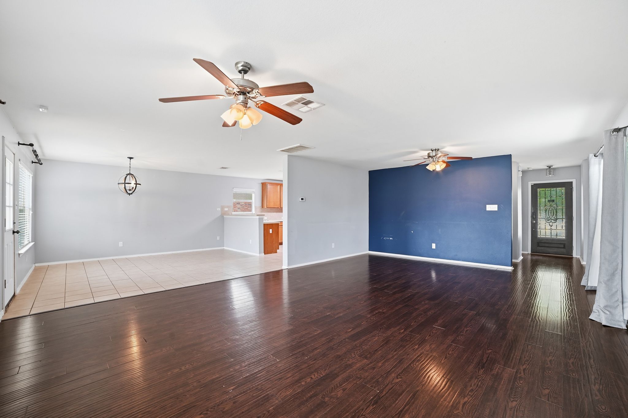 316 Housefinch Loop Leander, TX 78641 - Photo 14 of 37 an empty room with wooden floor and windows
