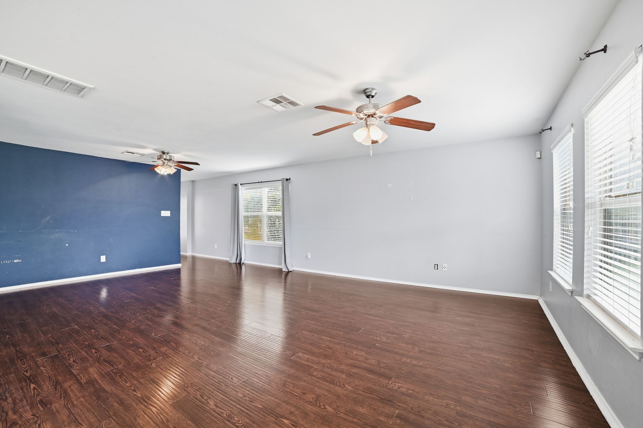 316 Housefinch Loop Leander, TX 78641 - Photo 15 of 37 an empty room with wooden floor and windows