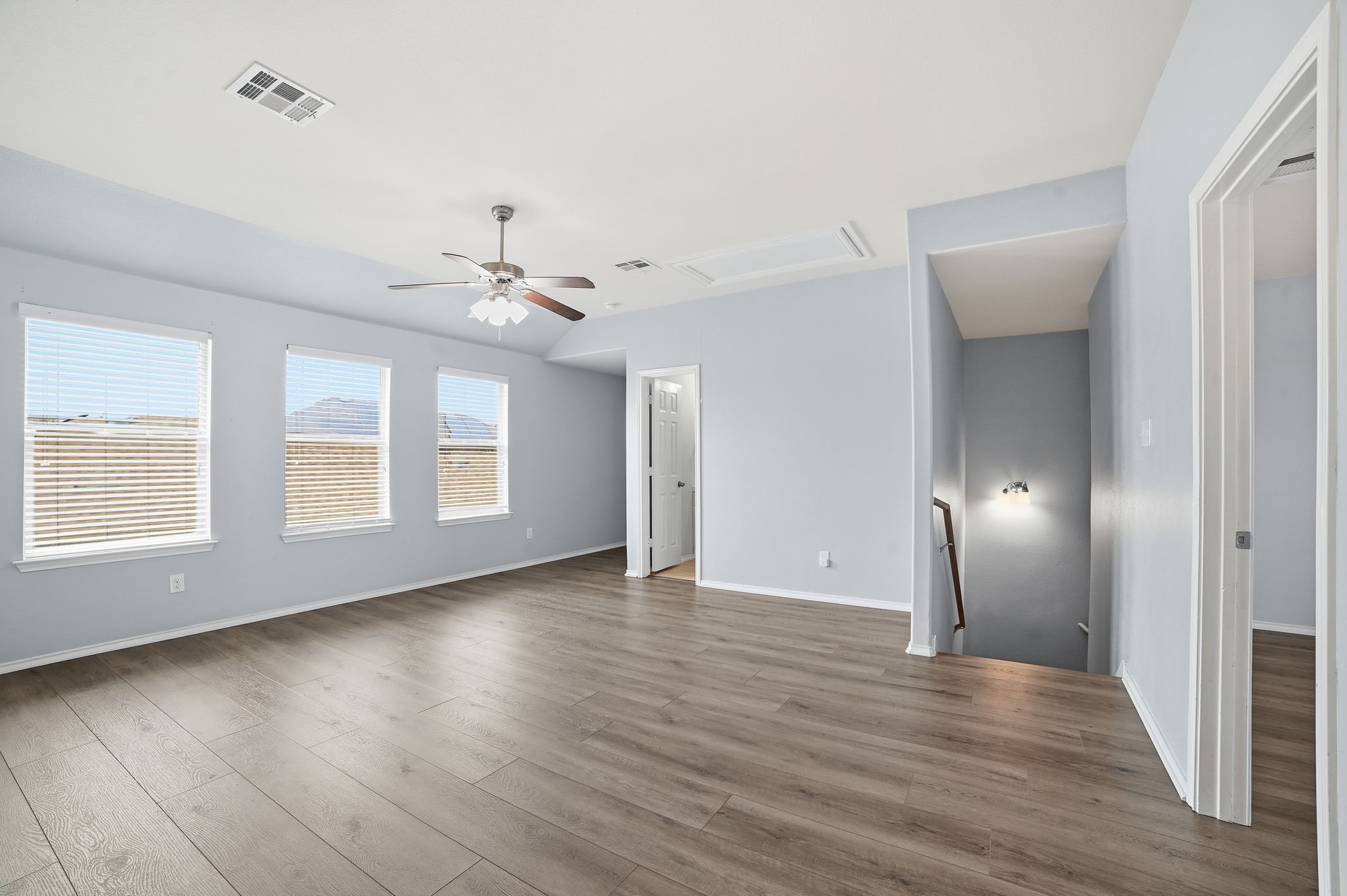 316 Housefinch Loop Leander, TX 78641 - Photo 17 of 37 a view of an empty room with wooden floor and a window