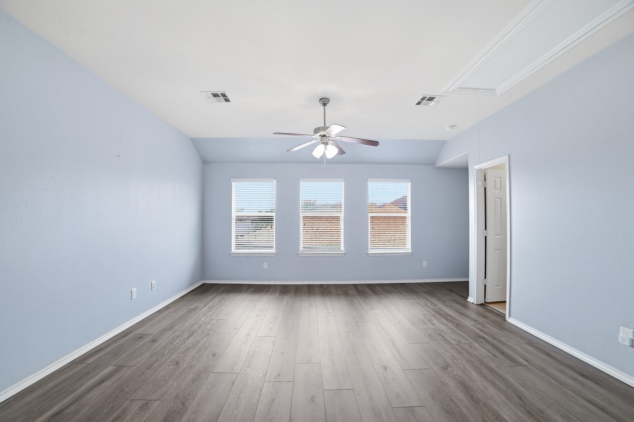 316 Housefinch Loop Leander, TX 78641 - Photo 19 of 37 a view of an empty room with wooden floor and a window