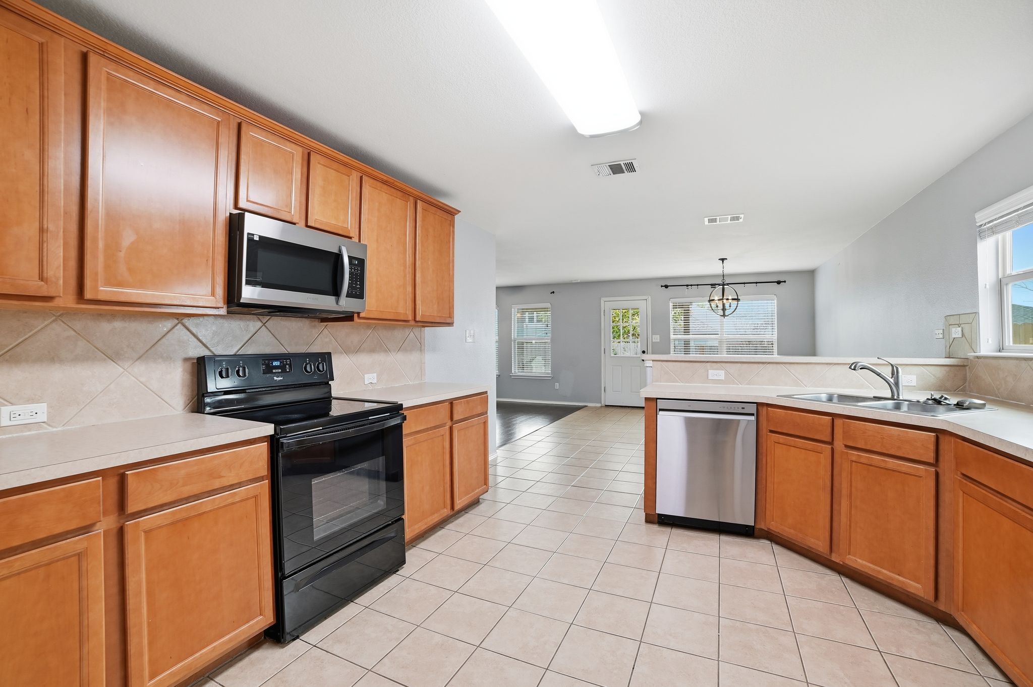 316 Housefinch Loop Leander, TX 78641 - Photo 2 of 37 Spacious kitchen with abundant cabinetry, tile floors, and ample counter space.