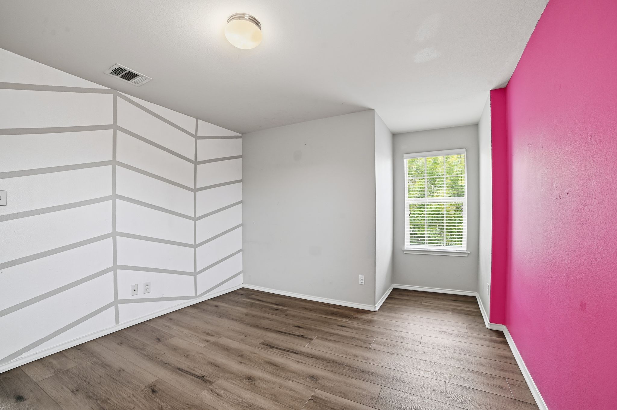 316 Housefinch Loop Leander, TX 78641 - Photo 25 of 37 wooden floor in an empty room with a window