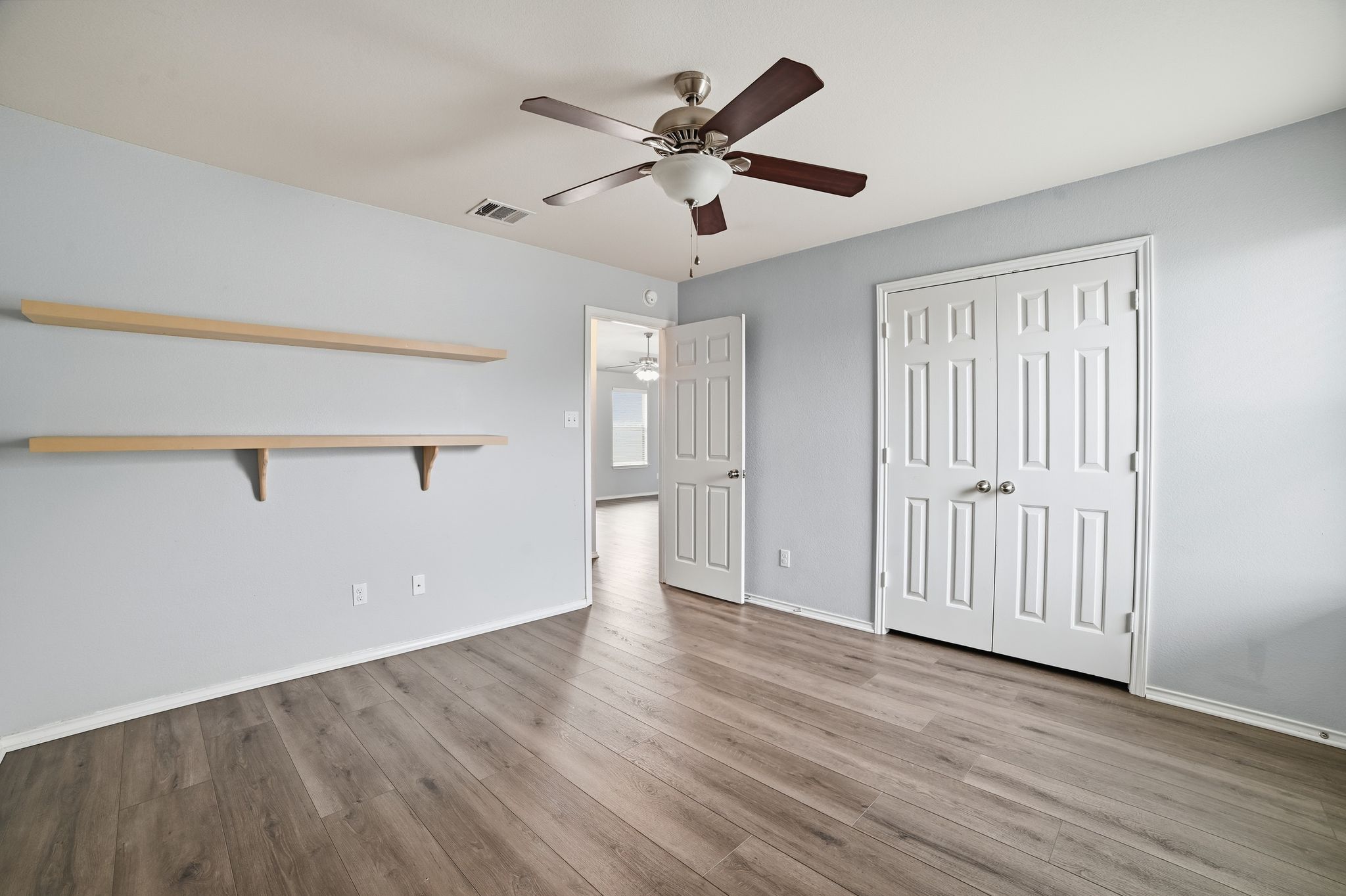 316 Housefinch Loop Leander, TX 78641 - Photo 27 of 37 wooden floor in an empty room with a window