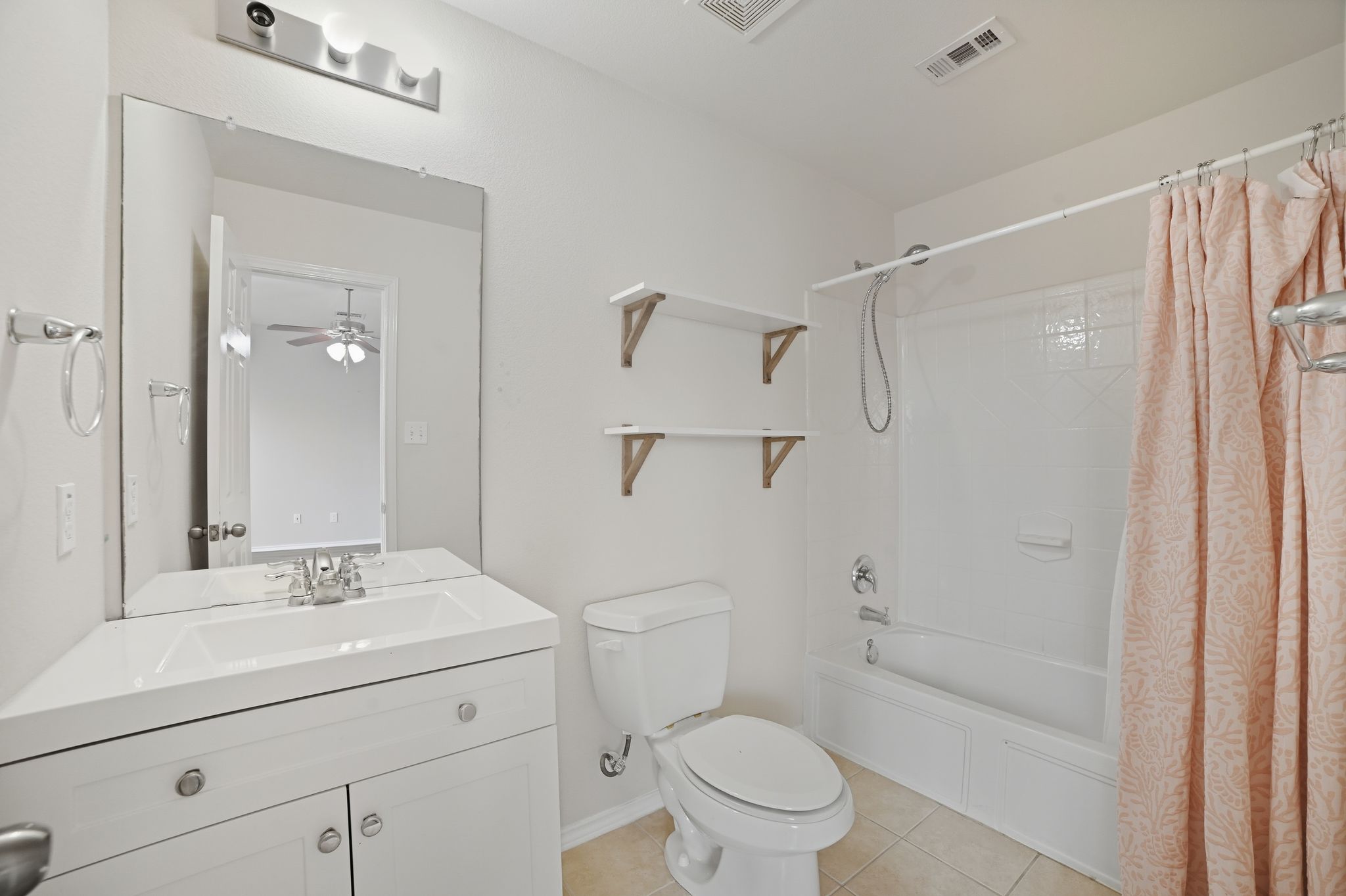 316 Housefinch Loop Leander, TX 78641 - Photo 28 of 37 a bathroom with a sink a mirror a toilet and shower