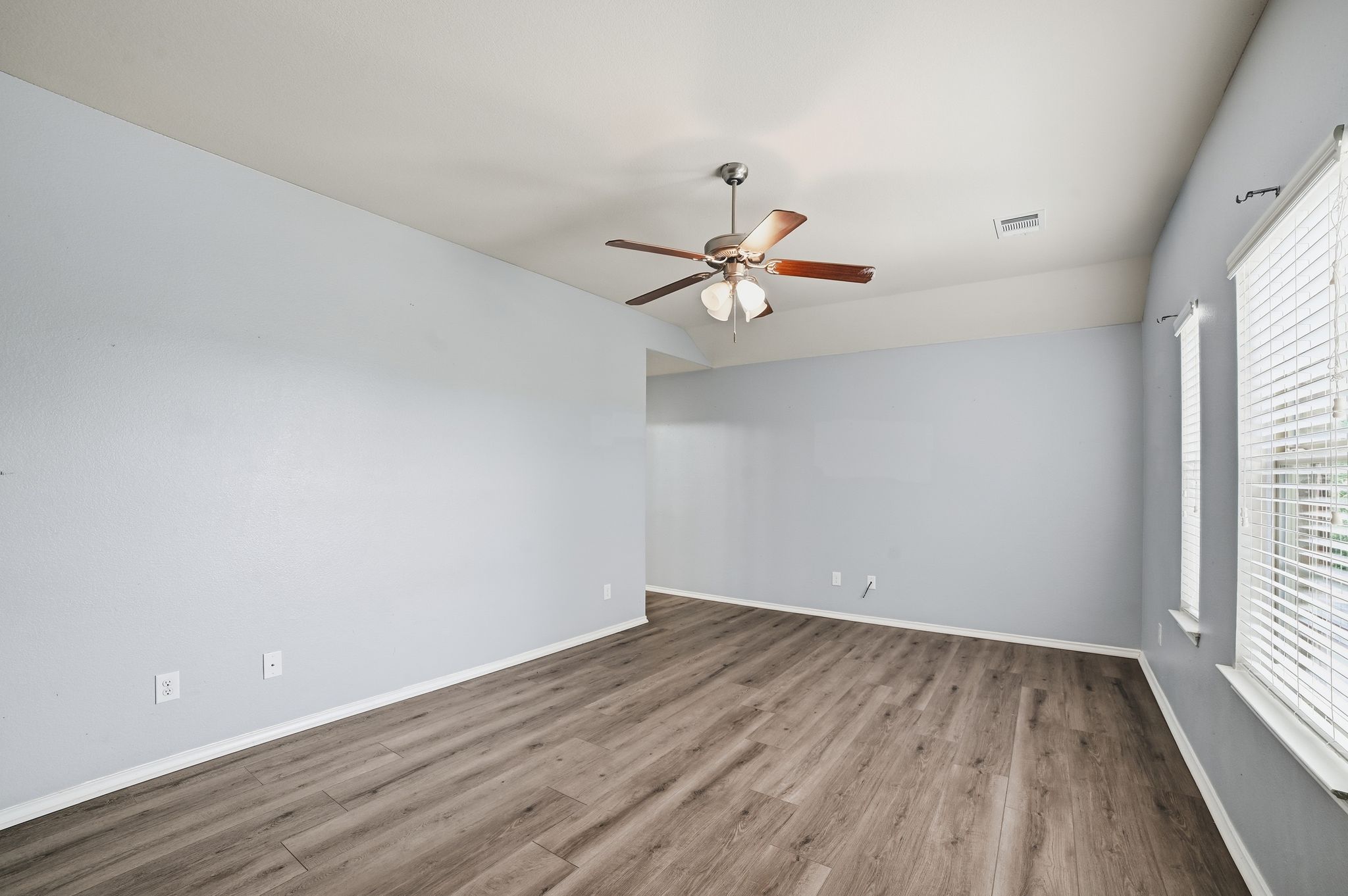 316 Housefinch Loop Leander, TX 78641 - Photo 29 of 37 wooden floor in an empty room with a window