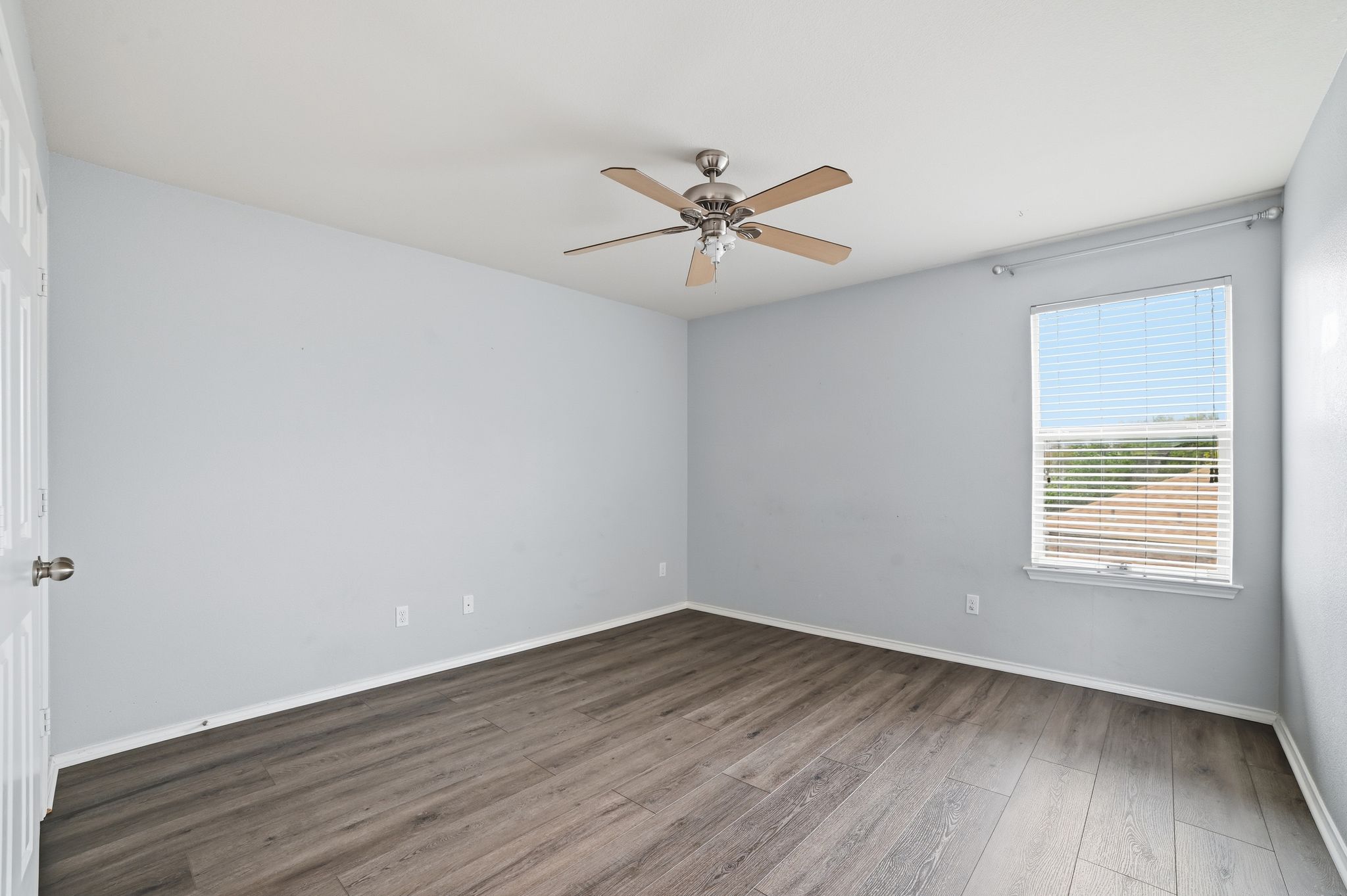 316 Housefinch Loop Leander, TX 78641 - Photo 30 of 37 an empty room with wooden floor fan and windows