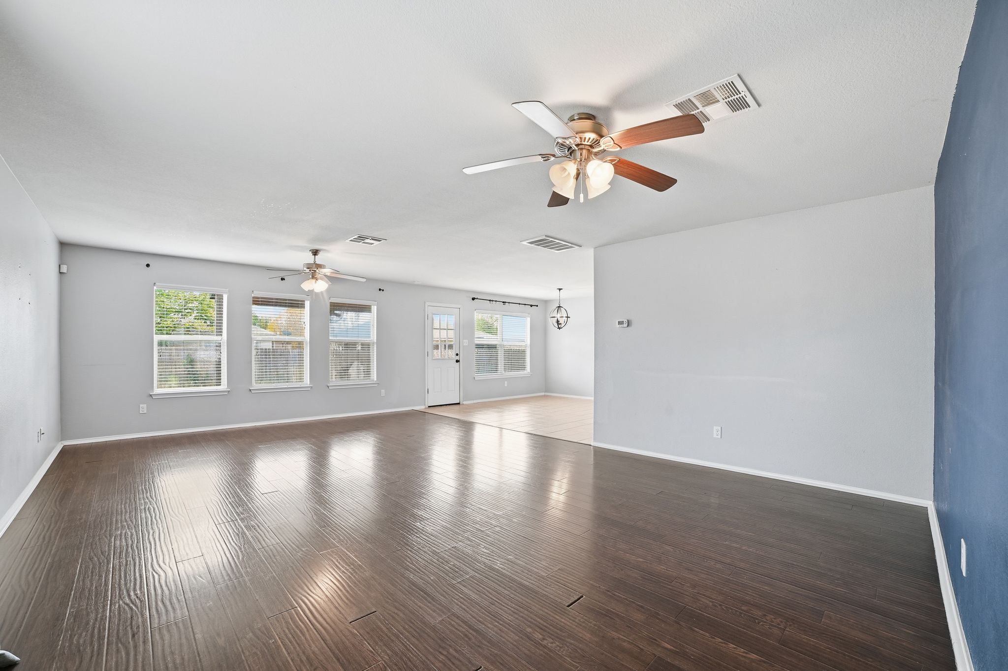 316 Housefinch Loop Leander, TX 78641 - Photo 4 of 37 a view of an empty room with wooden floor and a window