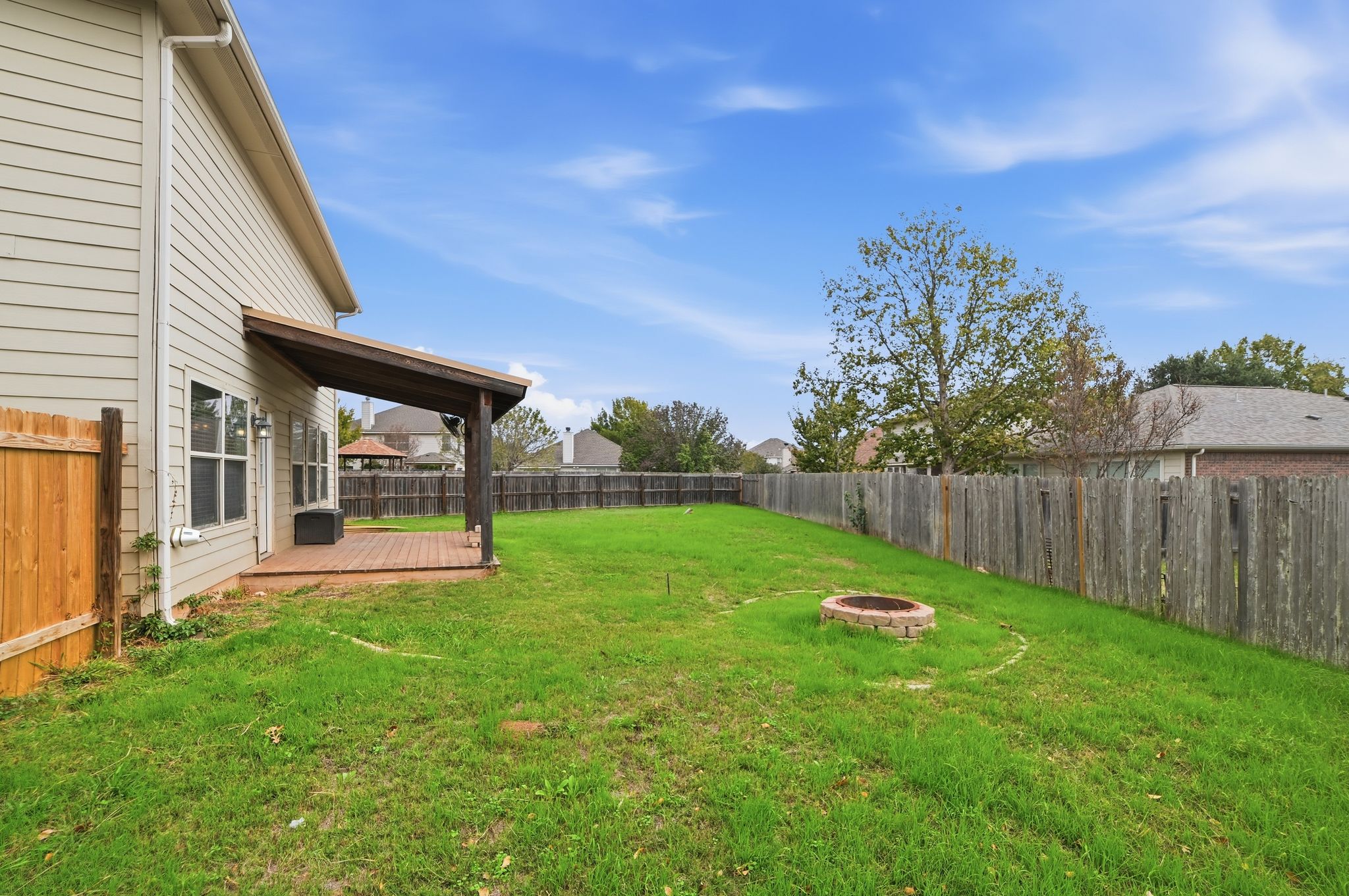 316 Housefinch Loop Leander, TX 78641 - Photo 5 of 37 a view of a backyard with table and chairs and potted plants