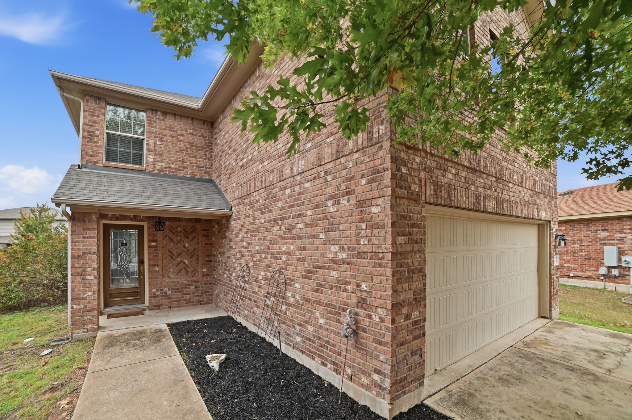 316 Housefinch Loop Leander, TX 78641 - Photo 7 of 37 Charming front elevation with covered entry and landscaped bed.