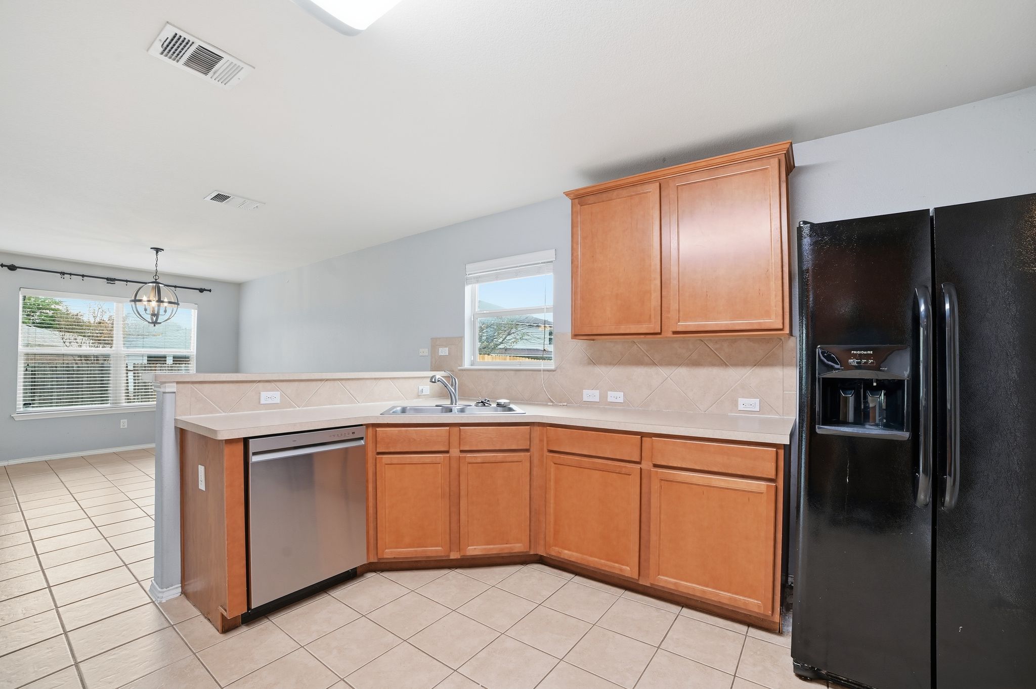 316 Housefinch Loop Leander, TX 78641 - Photo 9 of 37 a kitchen with stainless steel appliances granite countertop a sink and a refrigerator