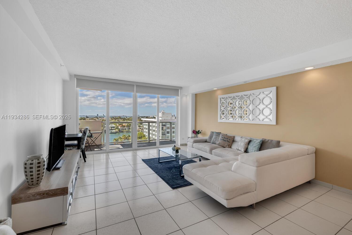 5601 Collins Avenue, Unit 1019 Miami Beach, FL 33140 - Photo 16 of 29 a living room with furniture and a floor to ceiling window