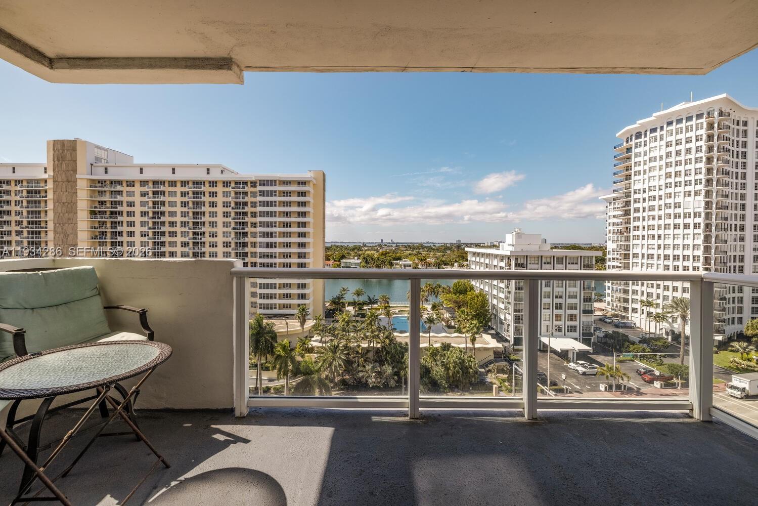 5601 Collins Avenue, Unit 1019 Miami Beach, FL 33140 - Photo 20 of 29 a view of a balcony with table and chairs
