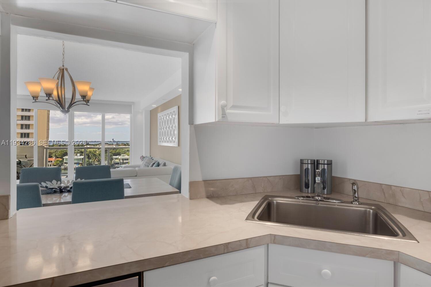 5601 Collins Avenue, Unit 1019 Miami Beach, FL 33140 - Photo 23 of 29 a kitchen with a sink cabinets and appliances