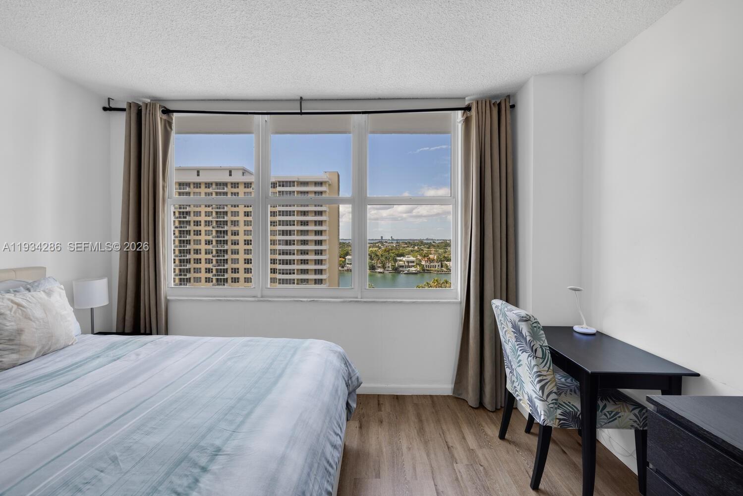 5601 Collins Avenue, Unit 1019 Miami Beach, FL 33140 - Photo 27 of 29 a bedroom with a bed and a window