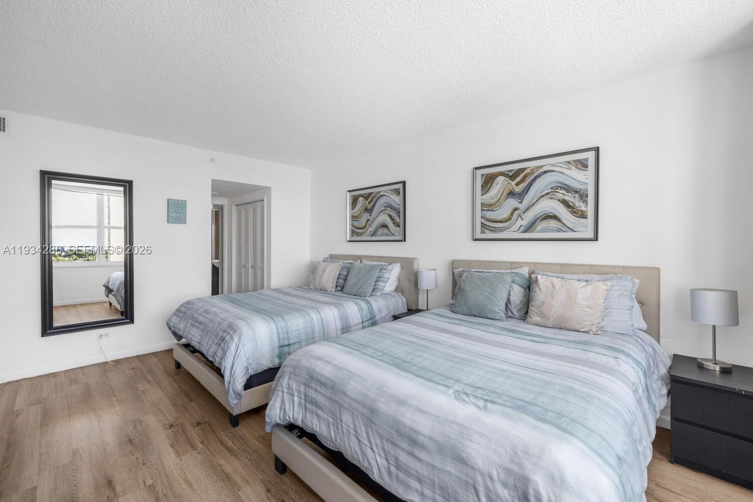 5601 Collins Avenue, Unit 1019 Miami Beach, FL 33140 - Photo 29 of 29 a bedroom with two beds and painting on the wall
